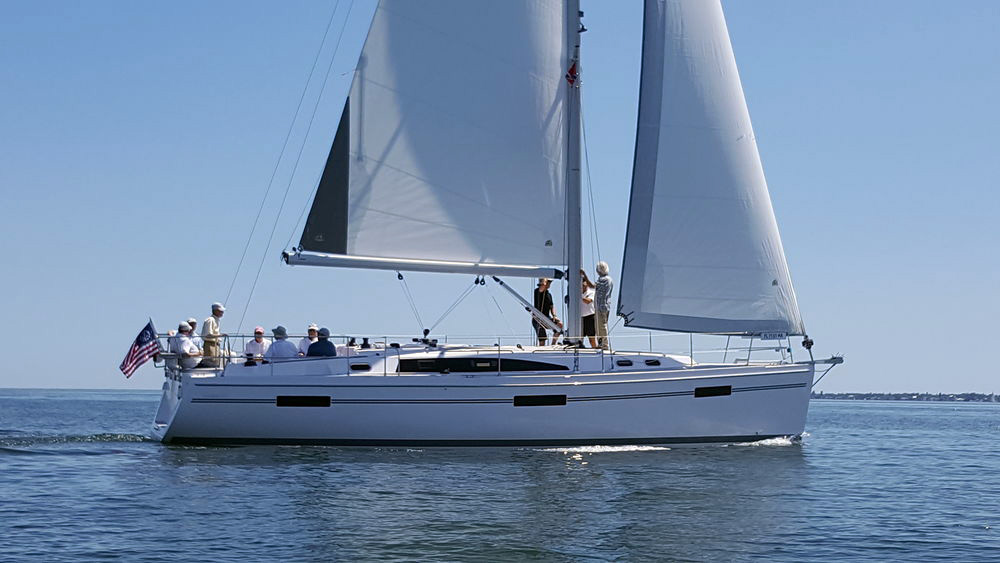 Catalina 425 sailing, with 10 adults pictured onboard